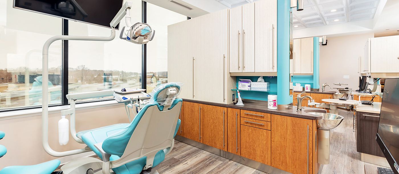 Treatment room at Aesthetic Smile Reconstruction in Waltham with natural light and ceiling-mounted screen